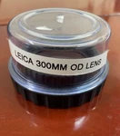 Leica Wild Surgical Microscope Dual Objective Lens 382168, F=300MM, 65MM Thread. Fixed Price $300.00.